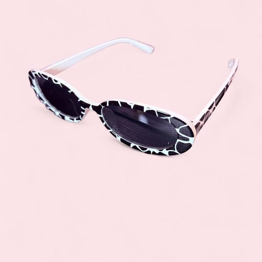 oval sunglasses featuring black-and-white cow print retro y2k edgy cow print